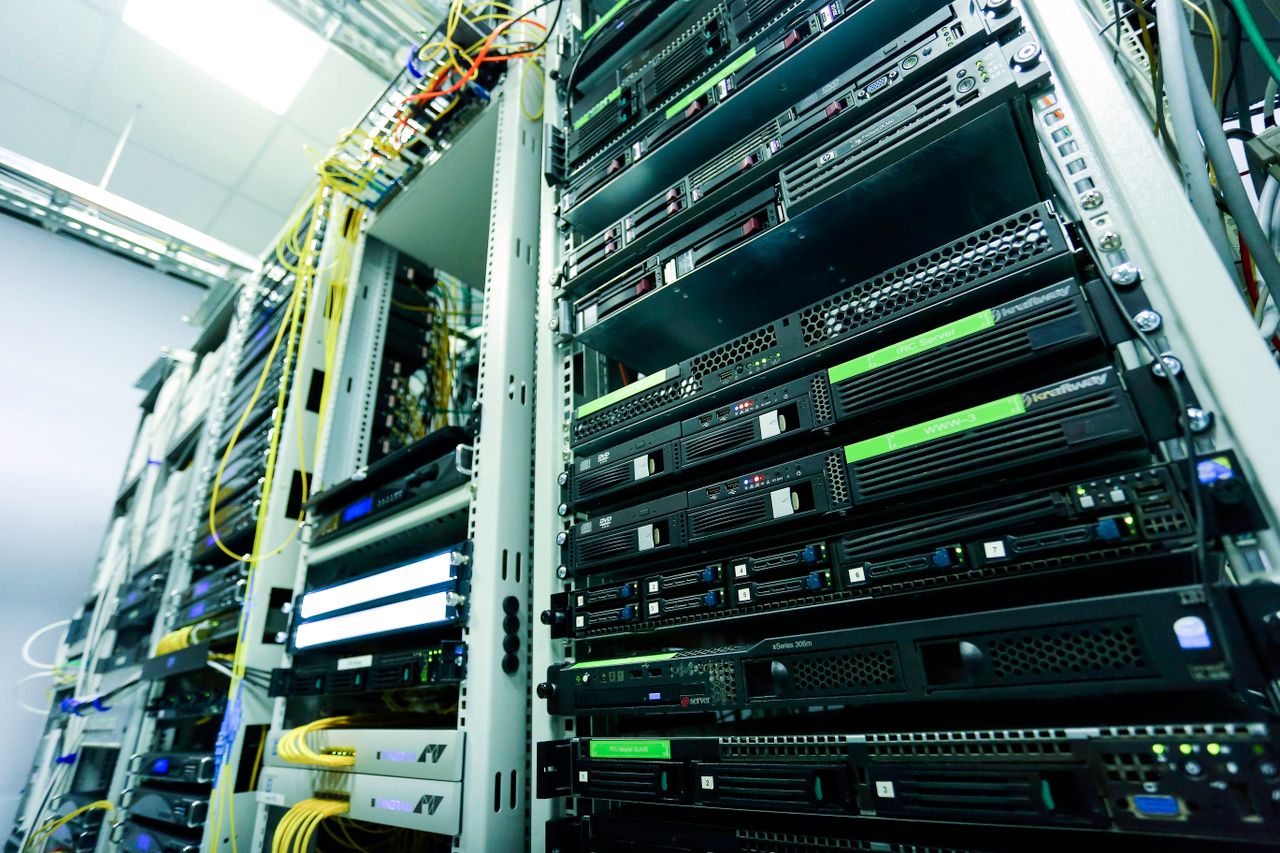 team-01 High-tech server rack in a secure data center with network cables and hardware components.